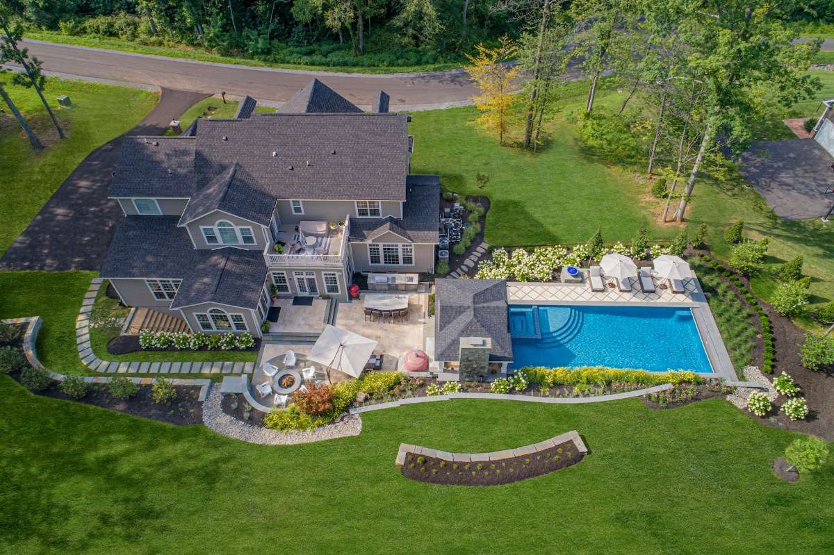 aerial photograph of pool with walkway firepit and pavilion