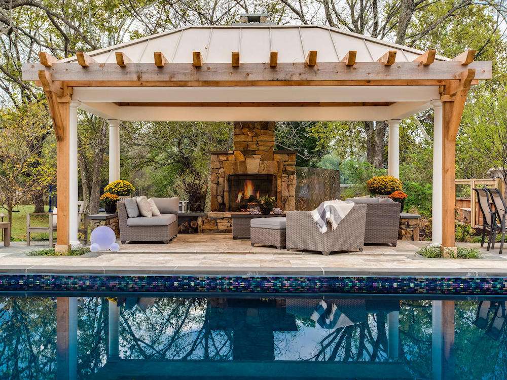 black bottom pool with pavilion and fireplace