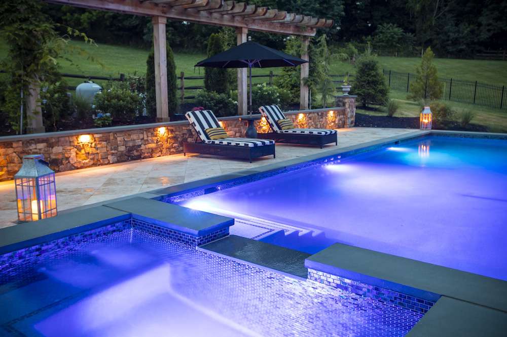 landscape lighting in retaining wall near pool