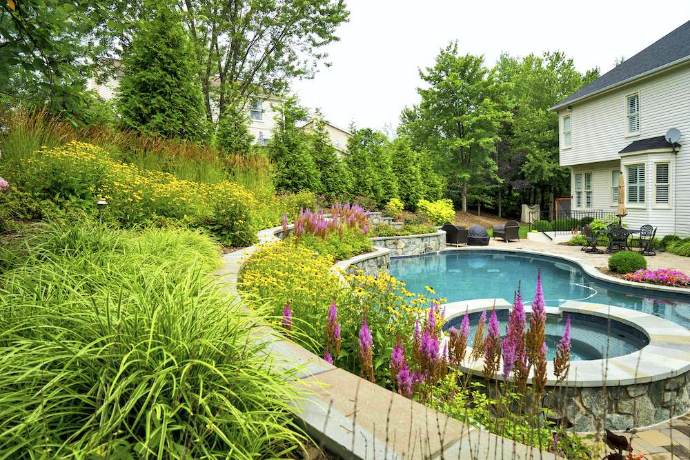 landscape design with pool custom rock wall and paver patio
