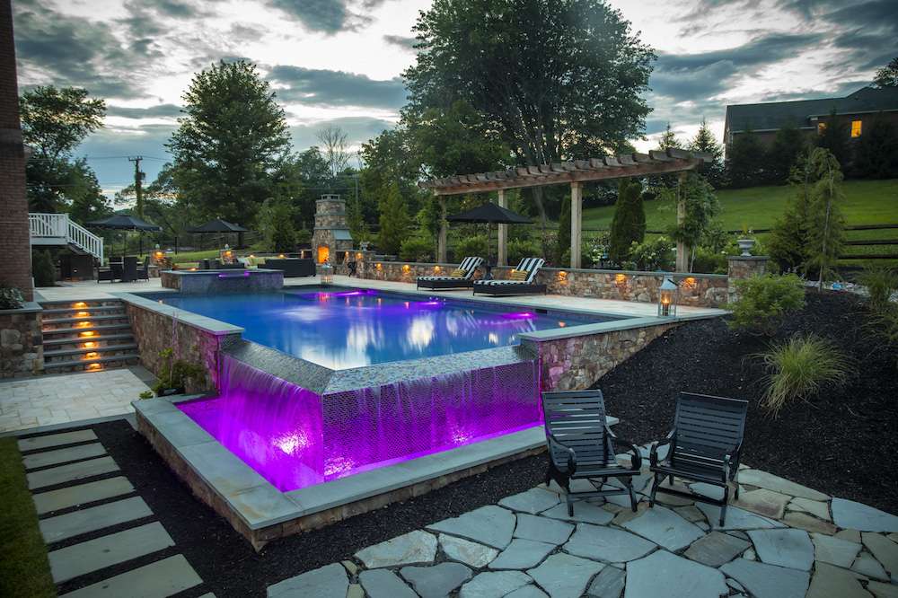 pool with waterfall and colored lights