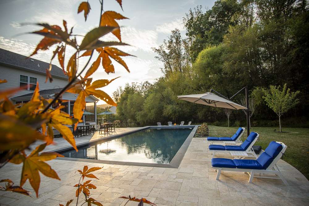 pool with large patio and firepit