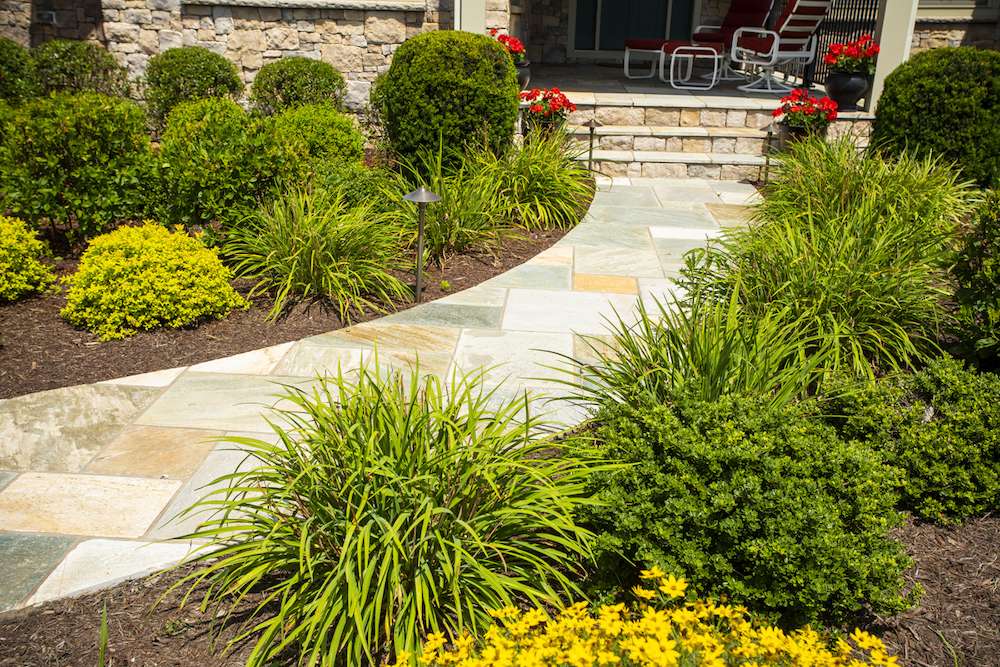 natural stone walkway leading up to front porch of home