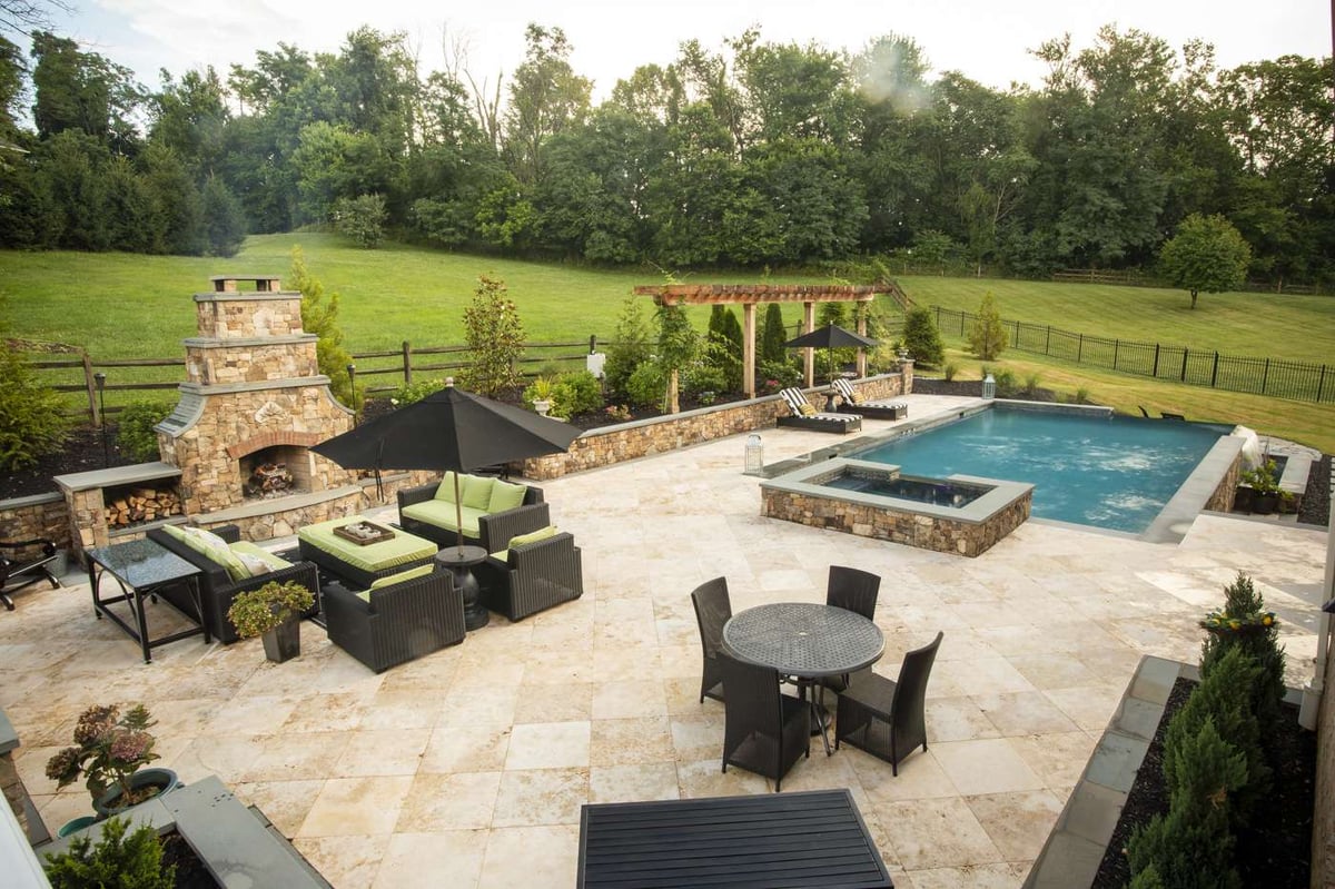 large sized patio with fireplace and pool