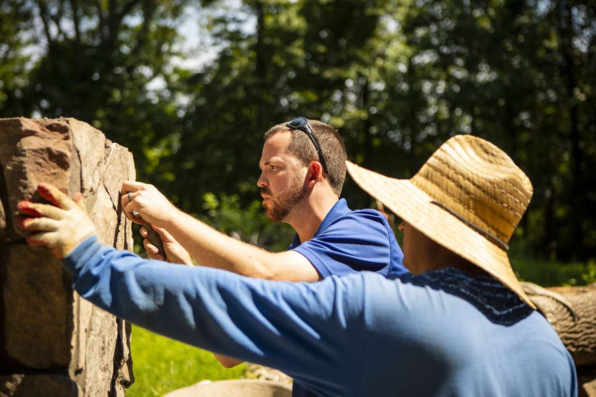 landscaping team installs hardscape wall