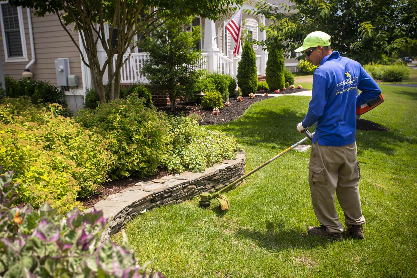 Landscape maintenance technician in lawn