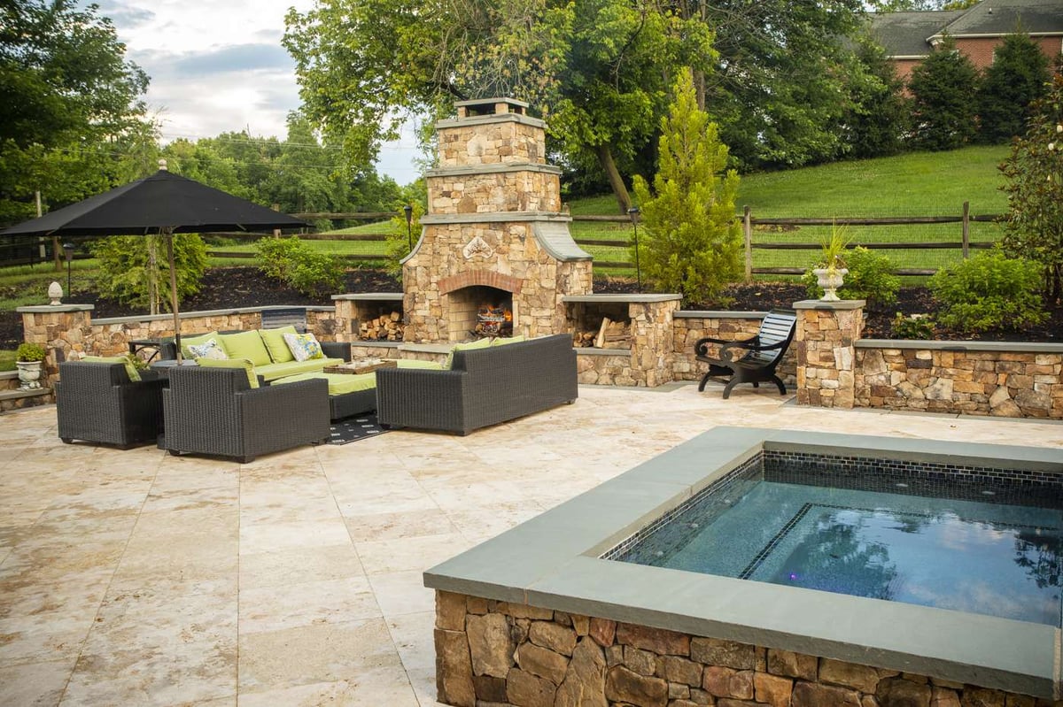 Patio with outdoor fireplace in Aldie, VA designed by Rock Water Farm