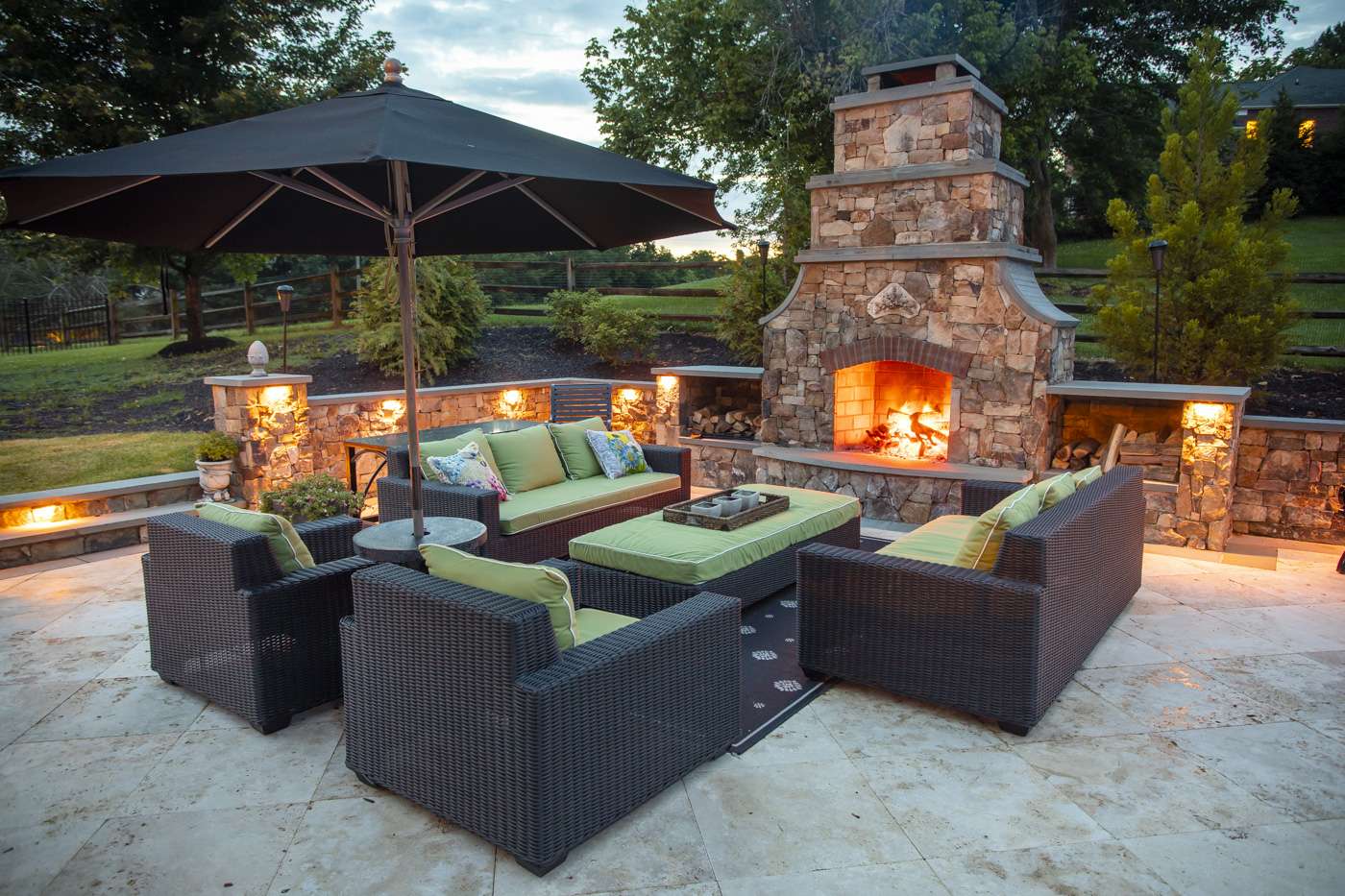 patio with outdoor fireplace and lighting designed by Rock Water Farm