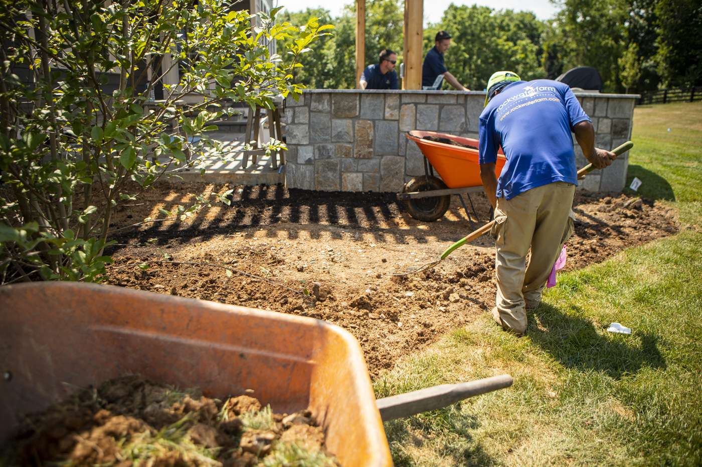 Landscapers regrading an area