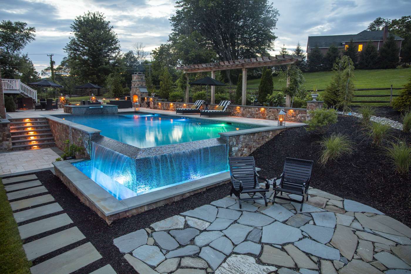 patio near infinity edge pool waterfall