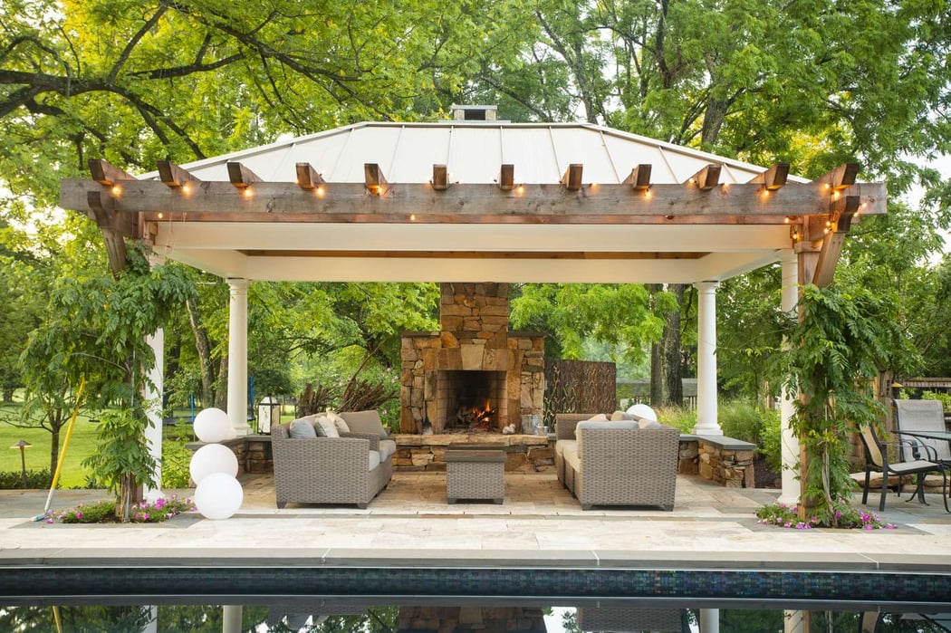 patio, outdoor fireplace, and pool designed by Rock Water Farm