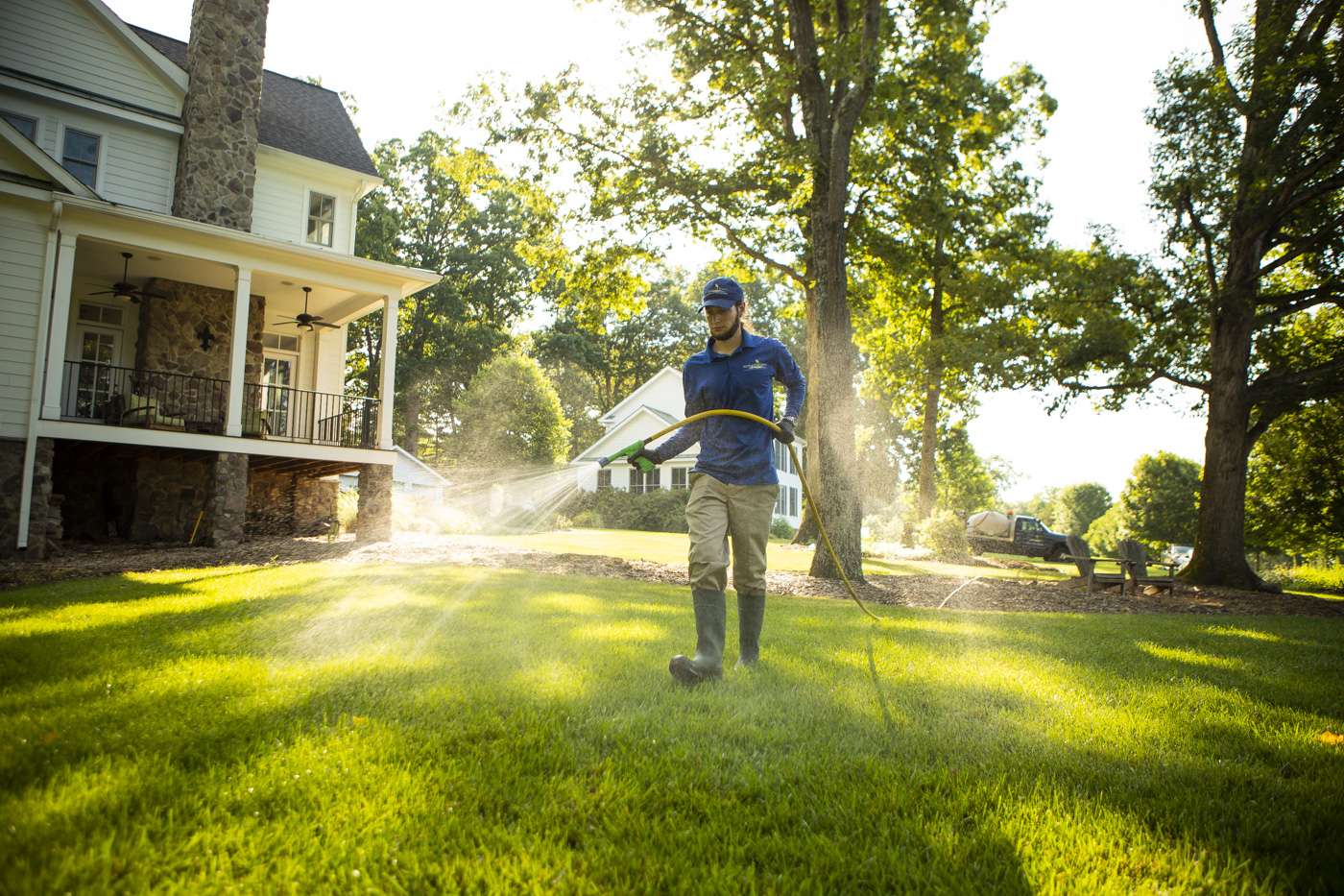 lawn care technician spraying lawn