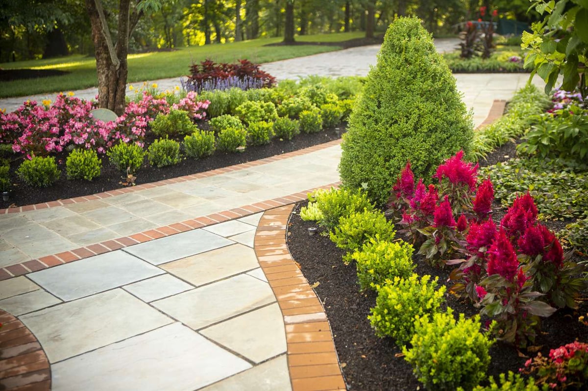 walkway with freshly mulched landscape beds and colorful plantings