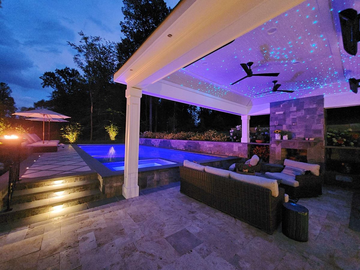 pool and pavilion with outdoor lighting