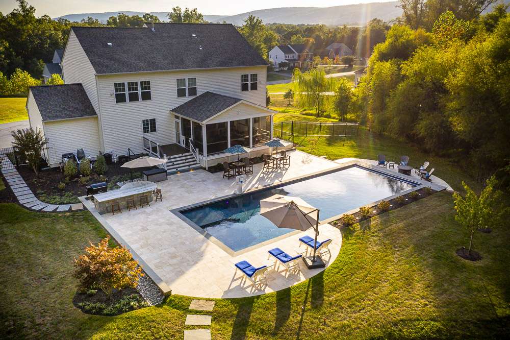 aerial view of pool, patio, and outdoor kitchen
