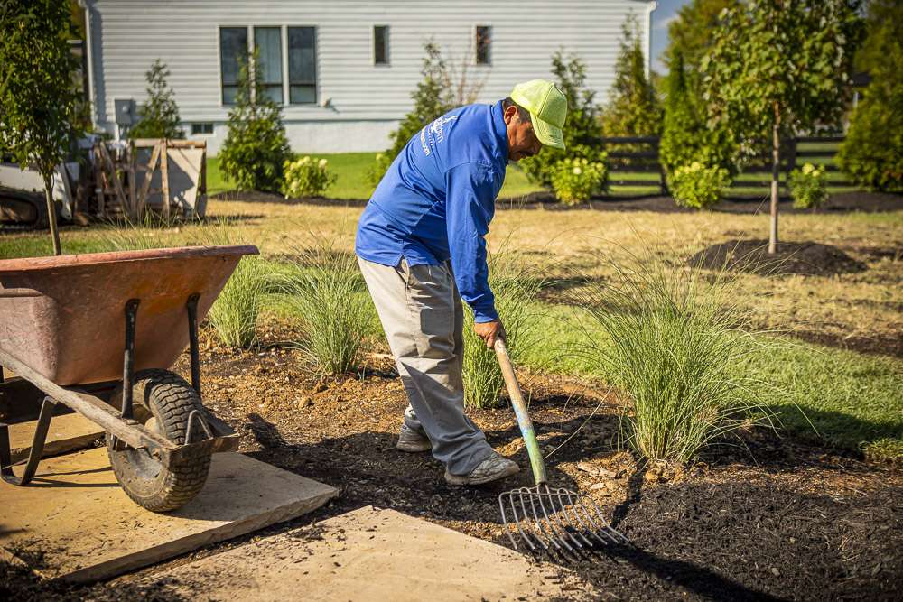 Rock Water crew mulching a landscape bed