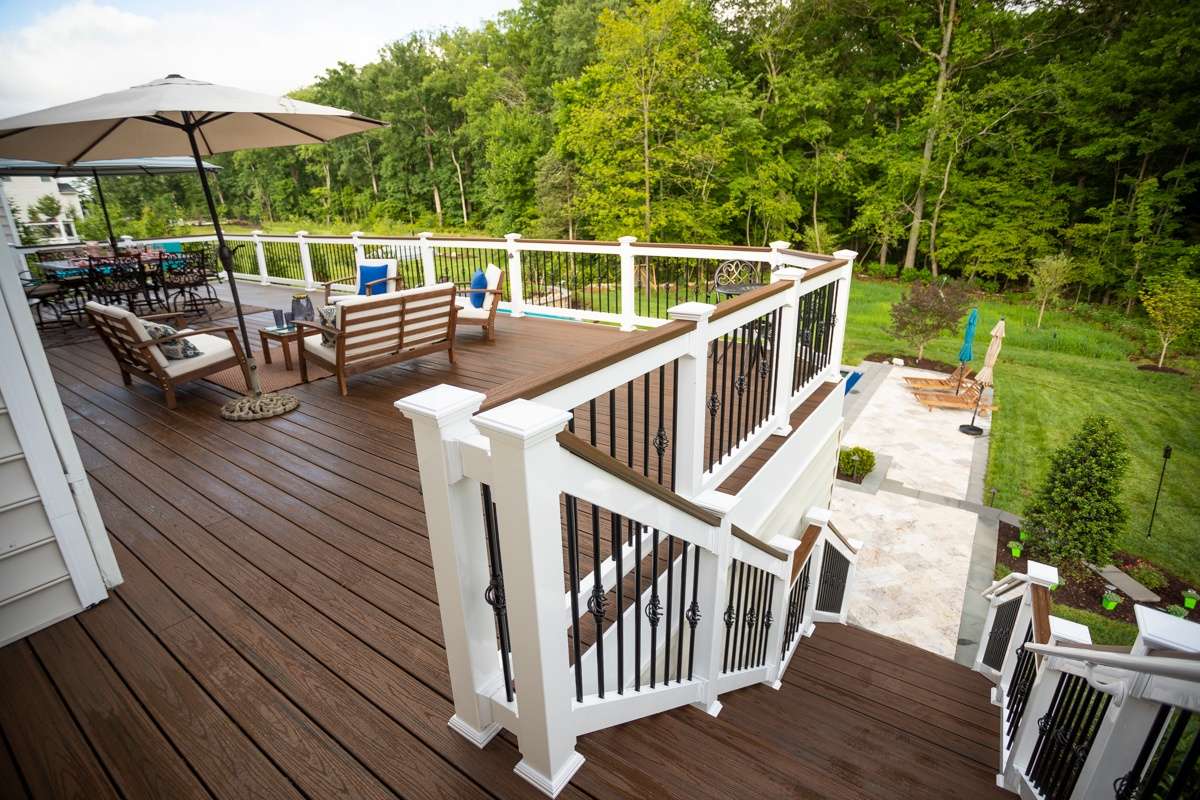 deck with patio and pool below