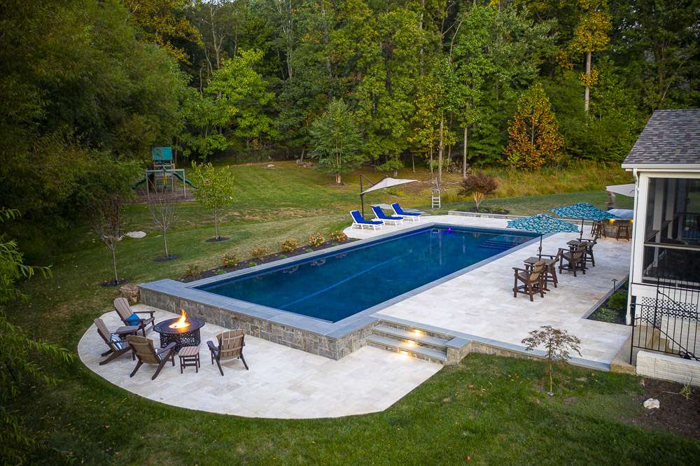 pool with firepit and patio