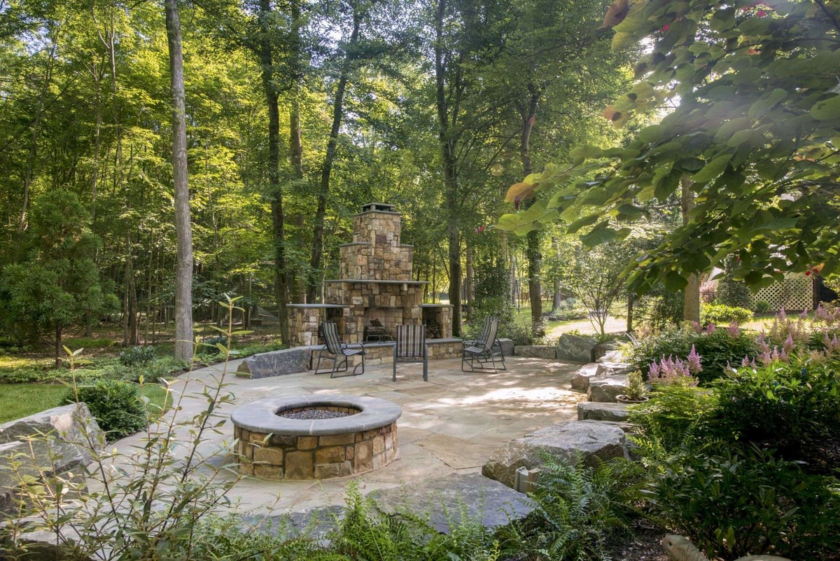 patio designed with outdoor fireplace and fire pit