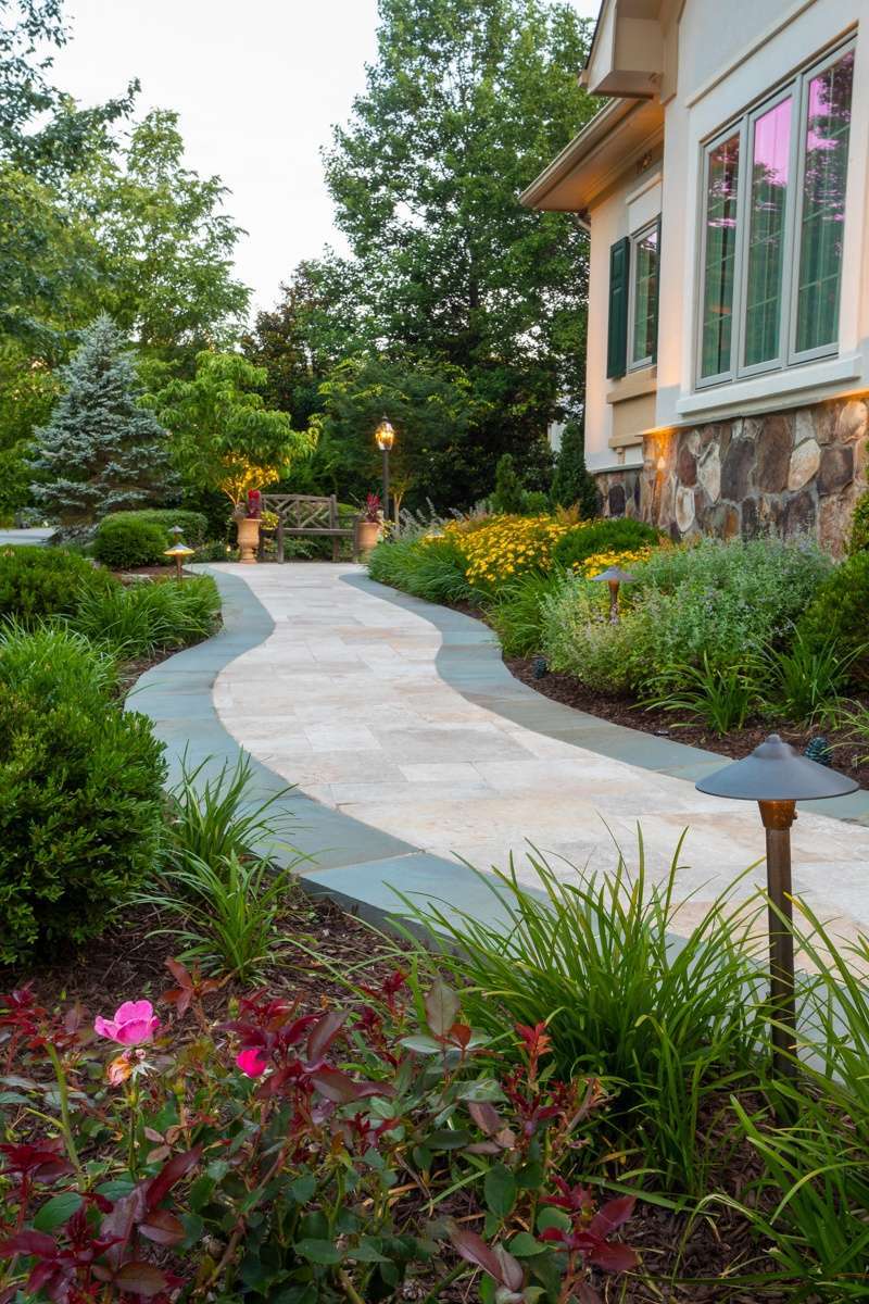 front yard and walkway with plants, shrubs, and trees