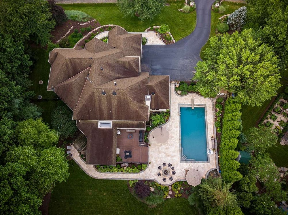stone walkway, pool, and private backyard aerial view