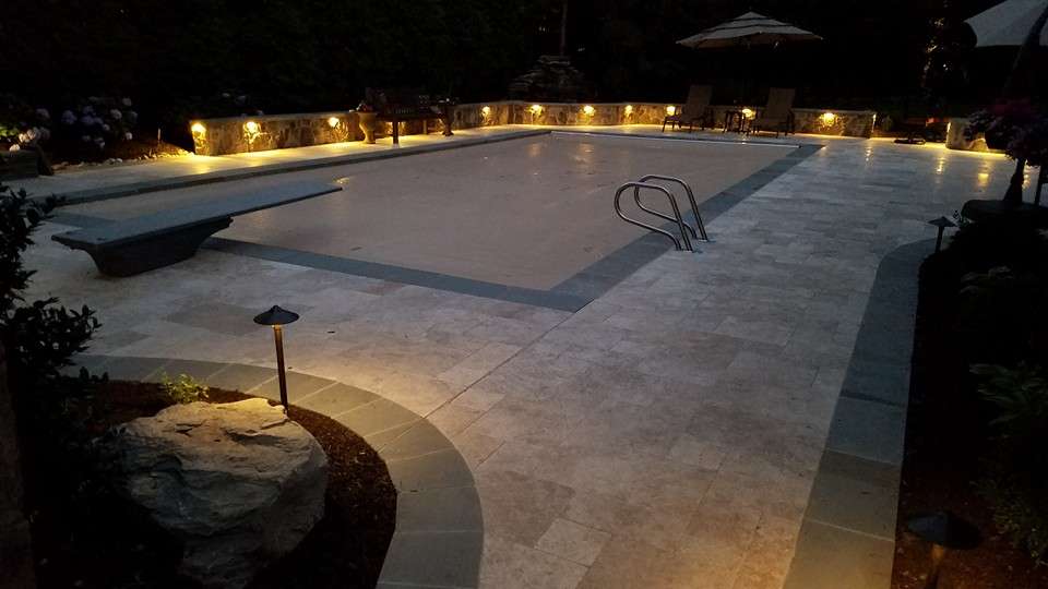 Travertine patio around a pool