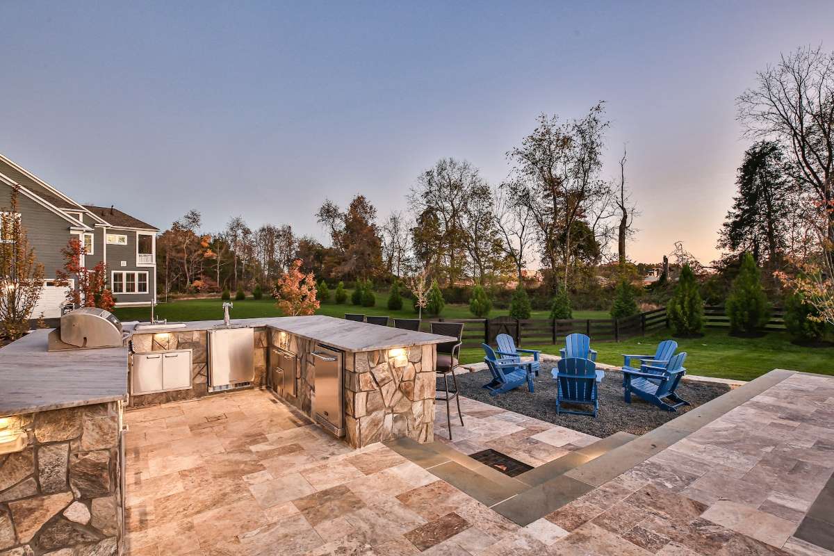 Outdoor kitchen with natural stone patio