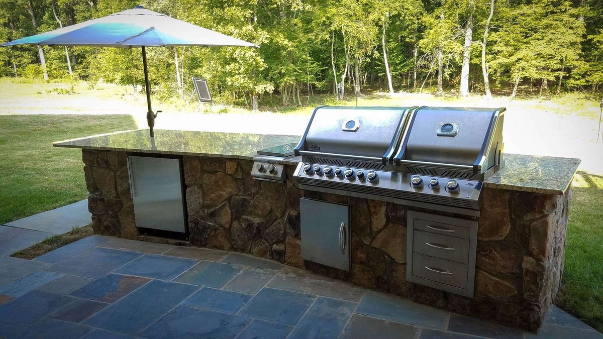 outdoor kitchen with stone and granite