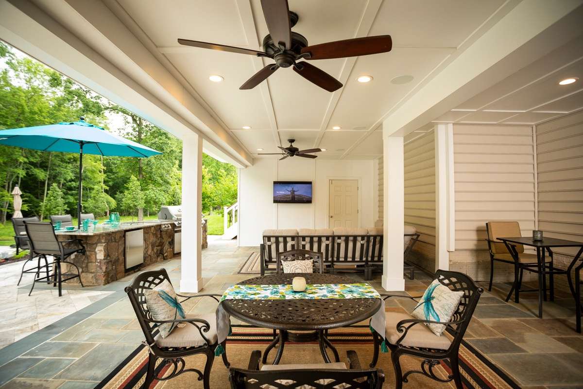 area under deck with outdoor kitchen patio and ceiling fans