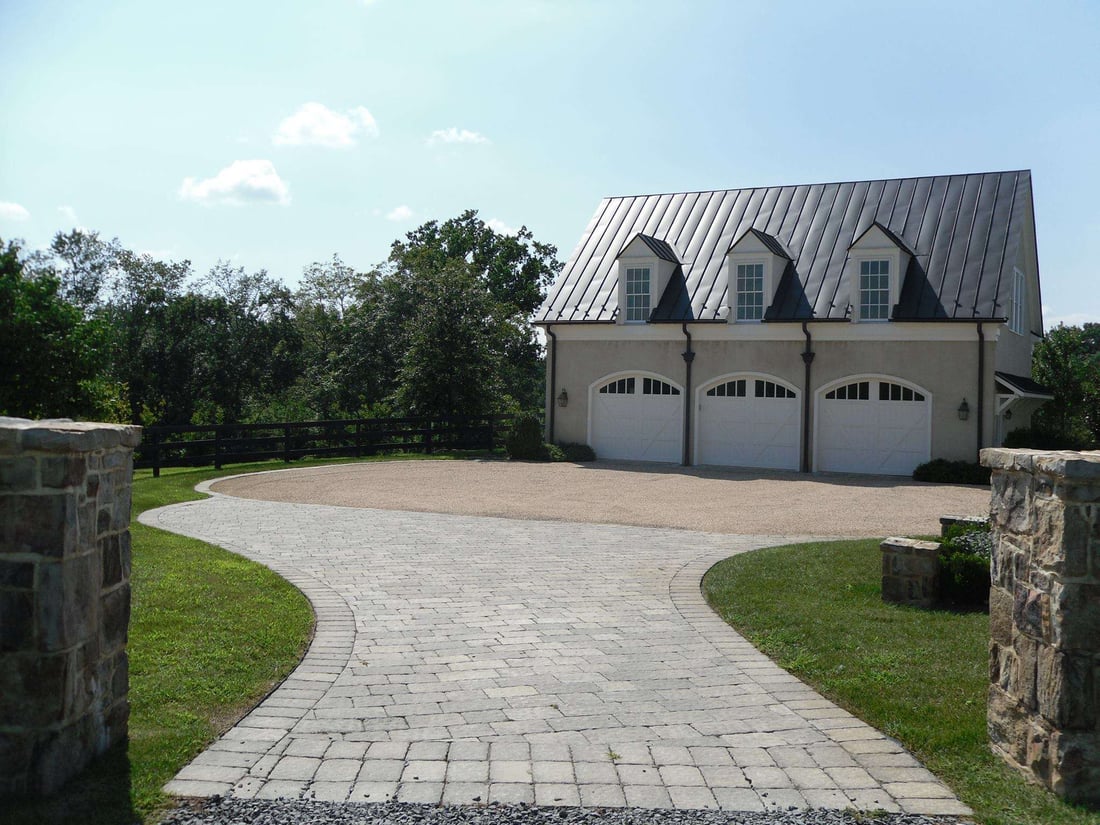 Paver driveway with stone pillars