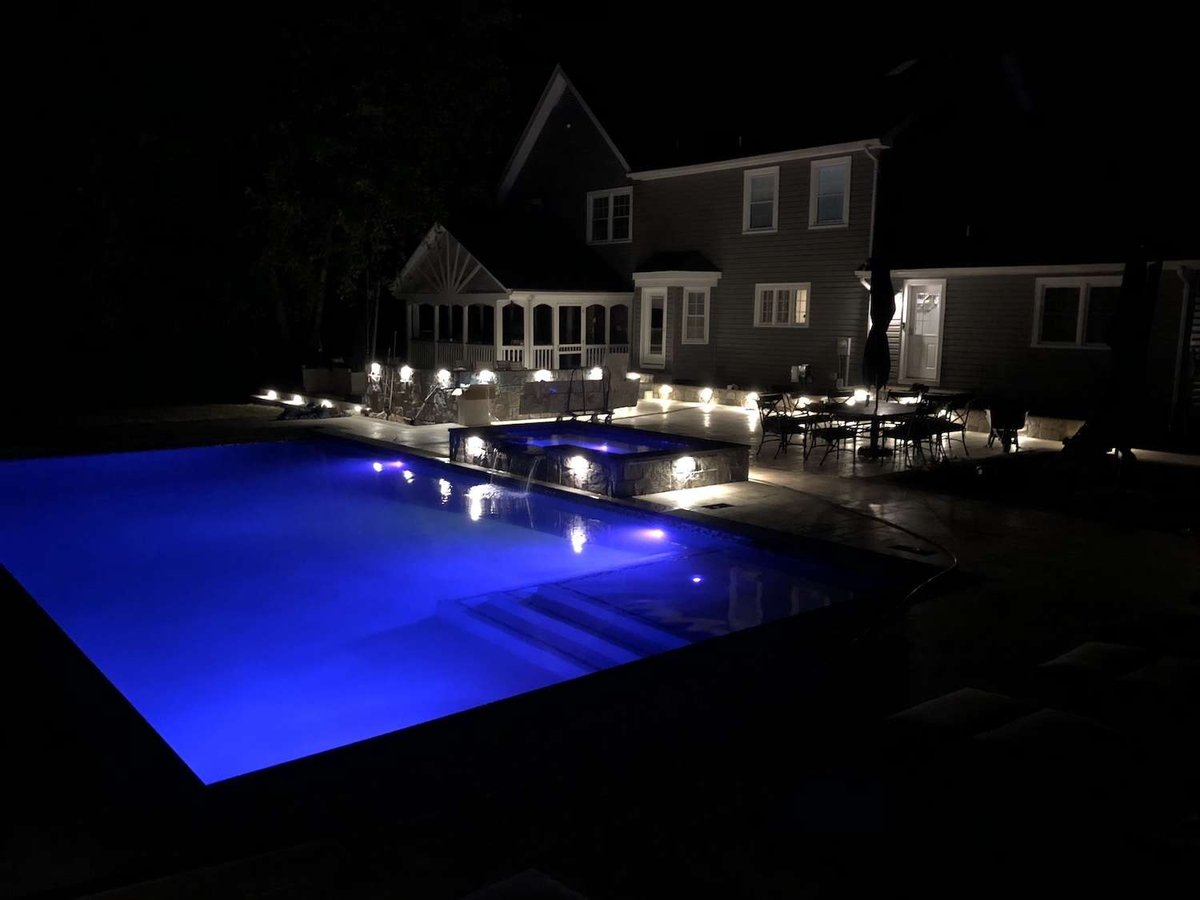 pool with hot tub and lighting