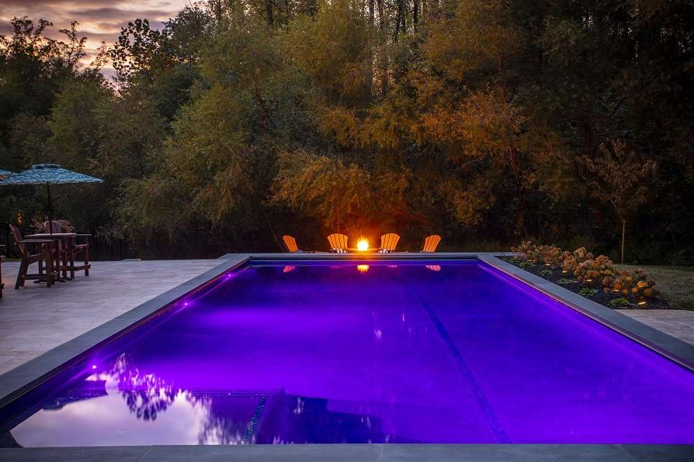 pool with custom led lighting and firepit