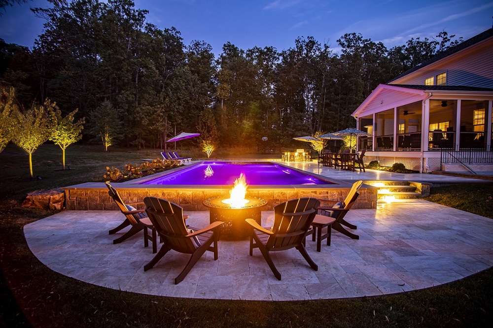 pool and patio fire pit at night in Round Hill, VA