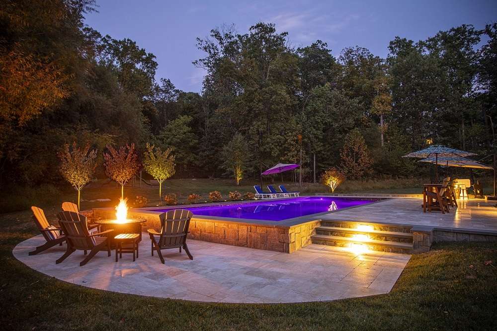 Patio and pool with beautiful landscape lighting