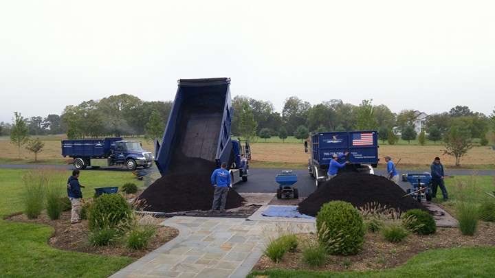 trucks dump mulch at property