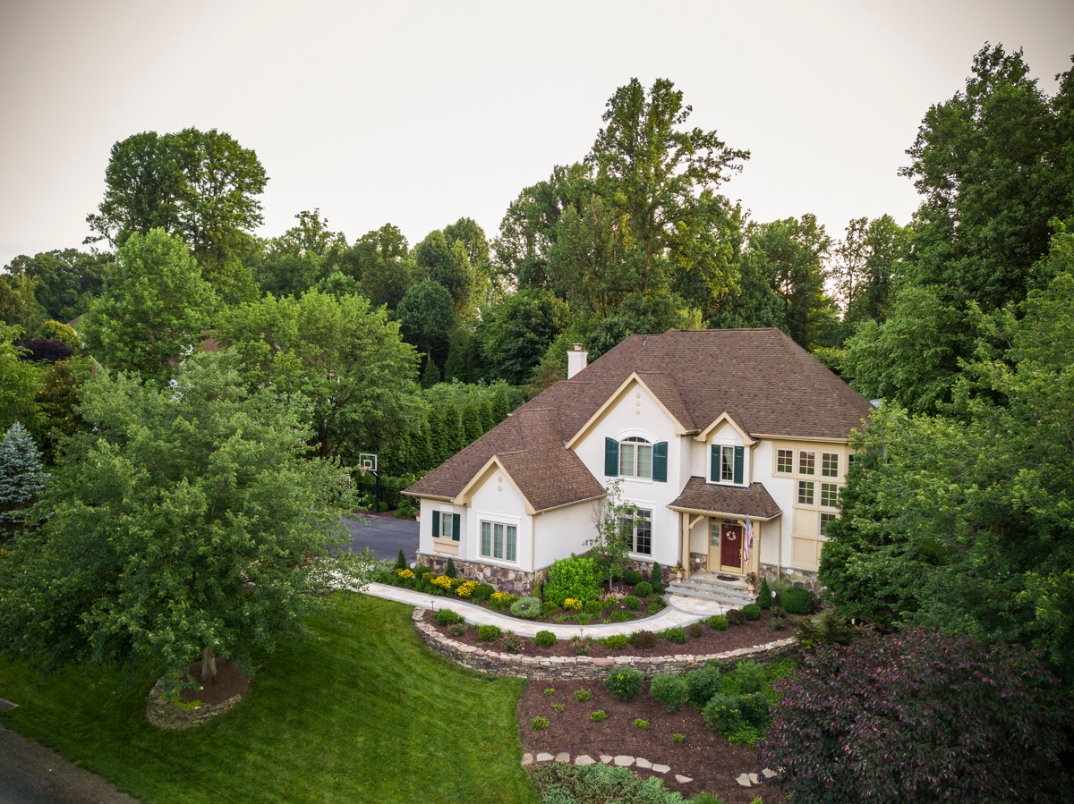 home with retaining wall and plantings