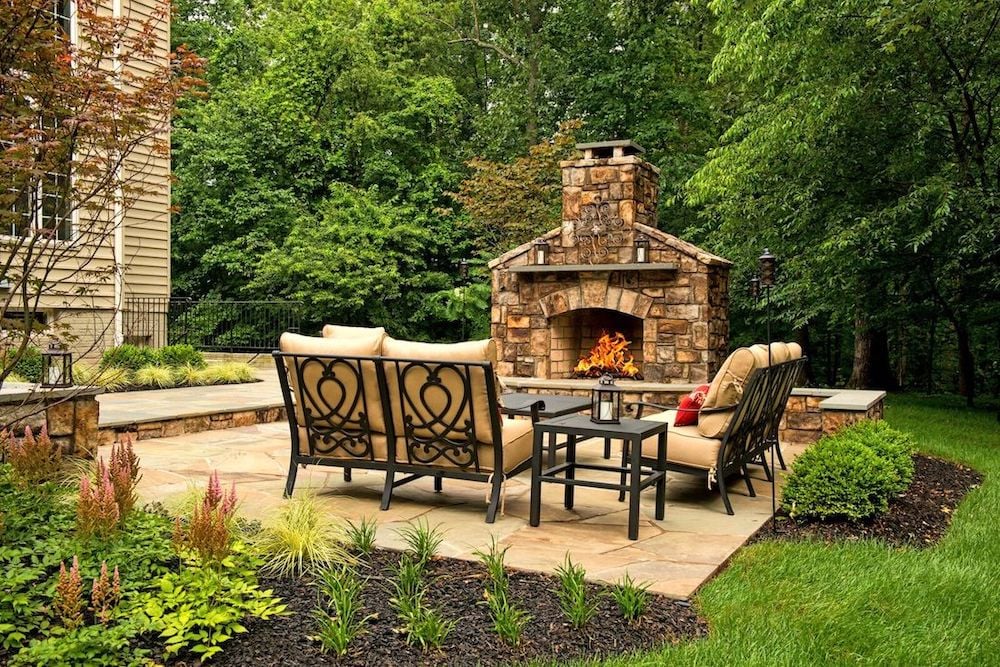 fireplace with patio and plantings
