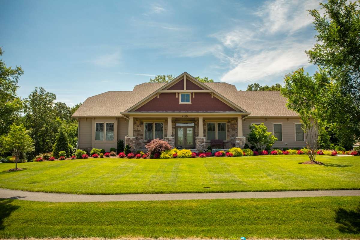 healthy grass in front of home with beautiful landscaping