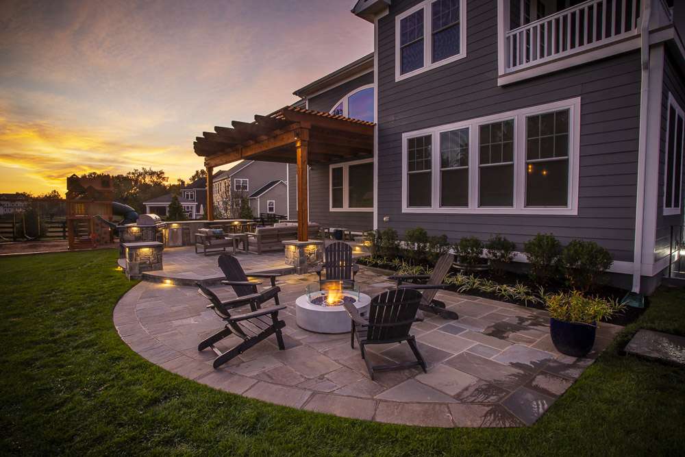 firepit with pergola and outdoor kitchen