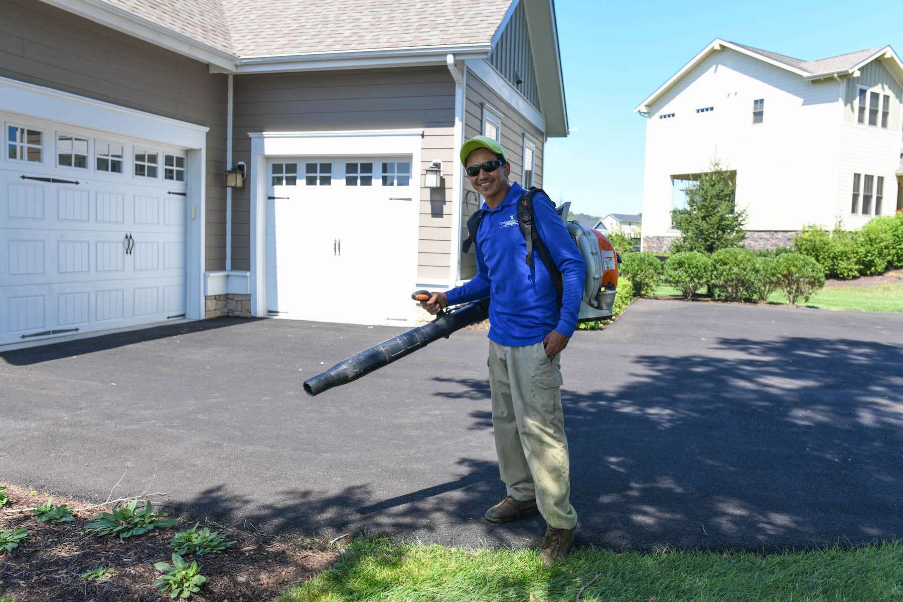 landscape maintenance team uses blower to clean up