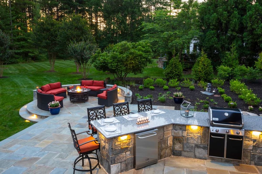 outdoor kitchen, patio, and fire pit with natural stone