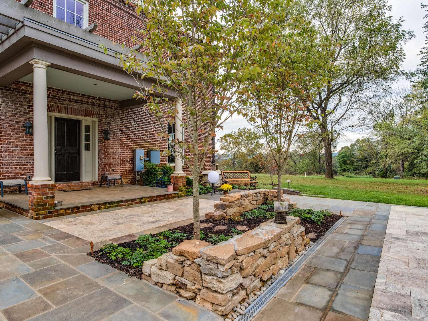 patio landscape designed with stone walls travertine and flagstone