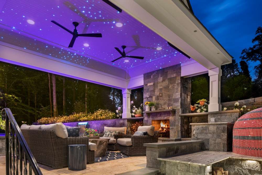 Pavilion with outdoor fireplace and ceiling fans