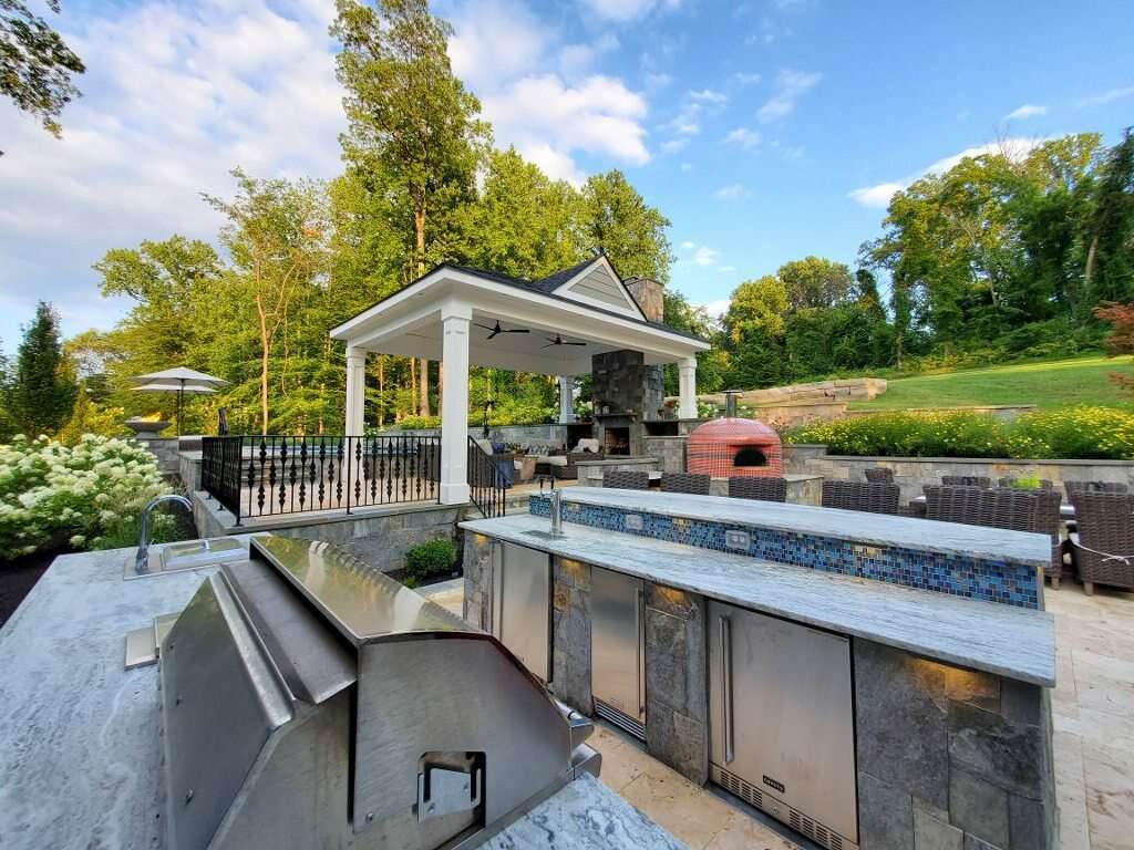 outdoor kitchen near pavilion and pool