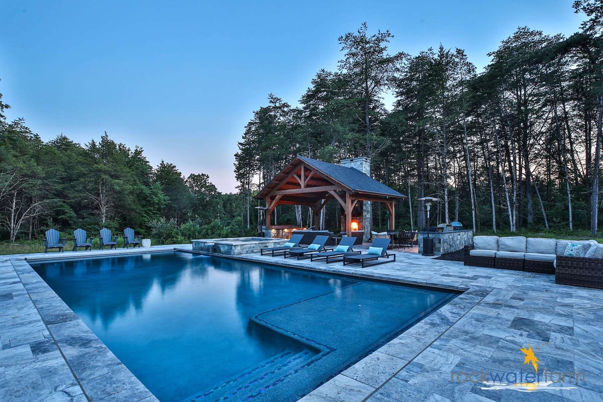 pool with custom patio pavilion and fireplace