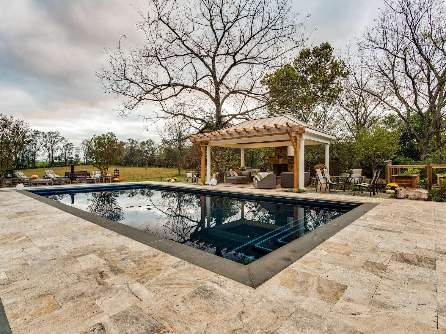 inground pool with pavilion and fireplace