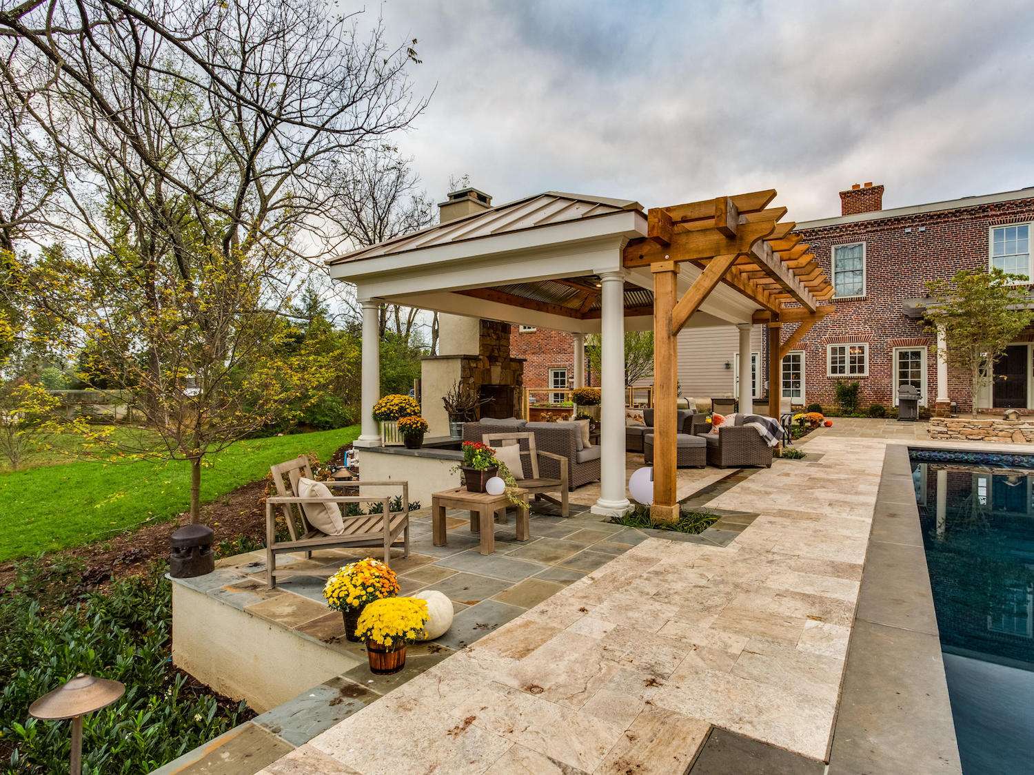 landscape design in Warrenton, VA with outdoor fireplace, pavilion, pool, and flagstone