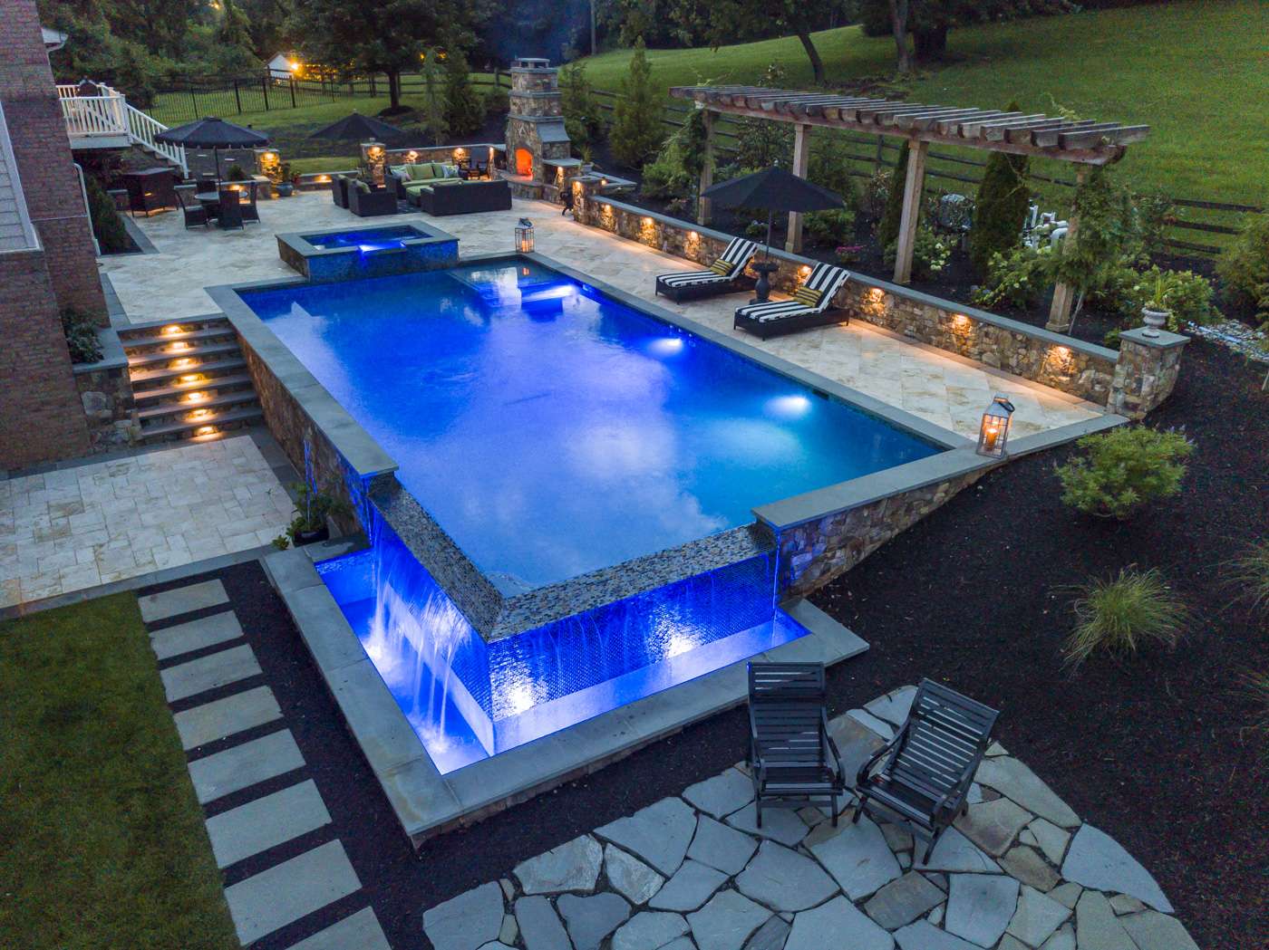 pool with custom lighting and infinity edge
