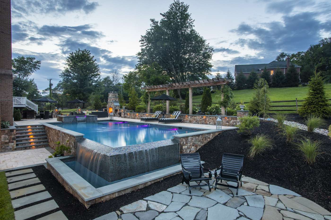 pool-lighting-infinity-edge-fireplace-stone-wall-1