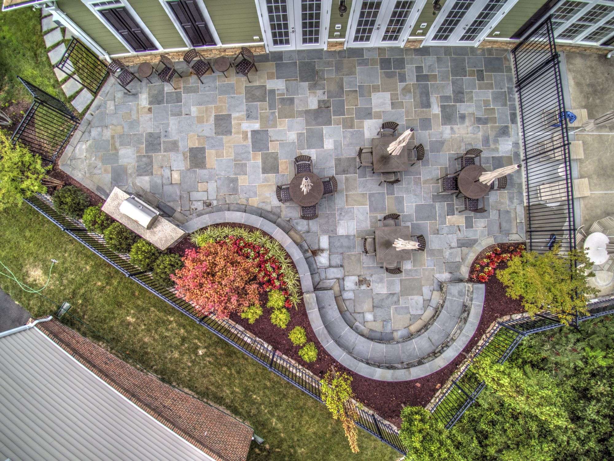 aerial photo of patio with outdoor kitchen and seating area